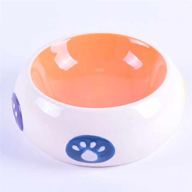 Tazón interior Naranja Tazón exterior Estilo de tambor blanco Huellas impresas Alimentador de cerámica para mascotas Tazón de cerámica para perros